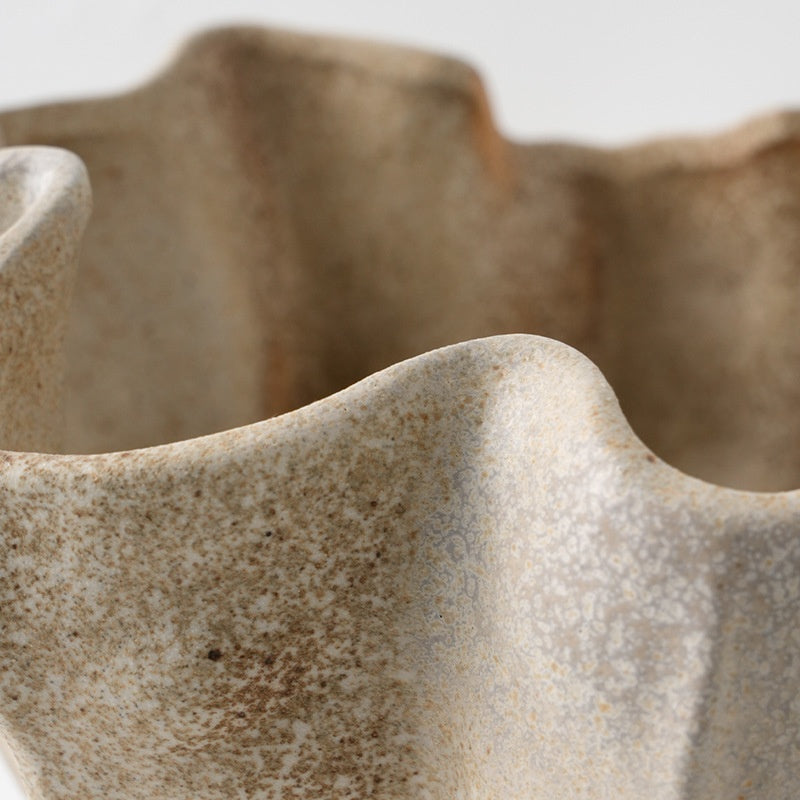 Close up of undulating rim and textured glaze