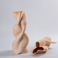Textured sand ceramic vase with twisted helical shape front view