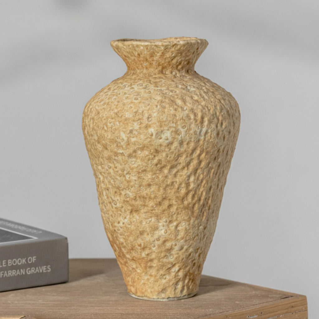 Textured sand ceramic vase on table
