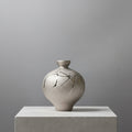 Textured silver ceramic bulbous vase with abstract markings