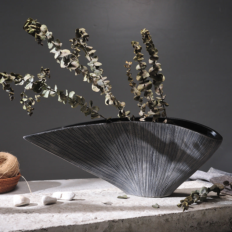 Textured silver resin boat vase with dried eucalyptus branches