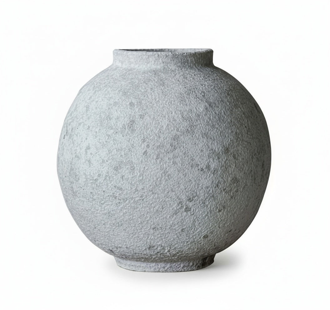 Textured stone finish spherical vase on white background