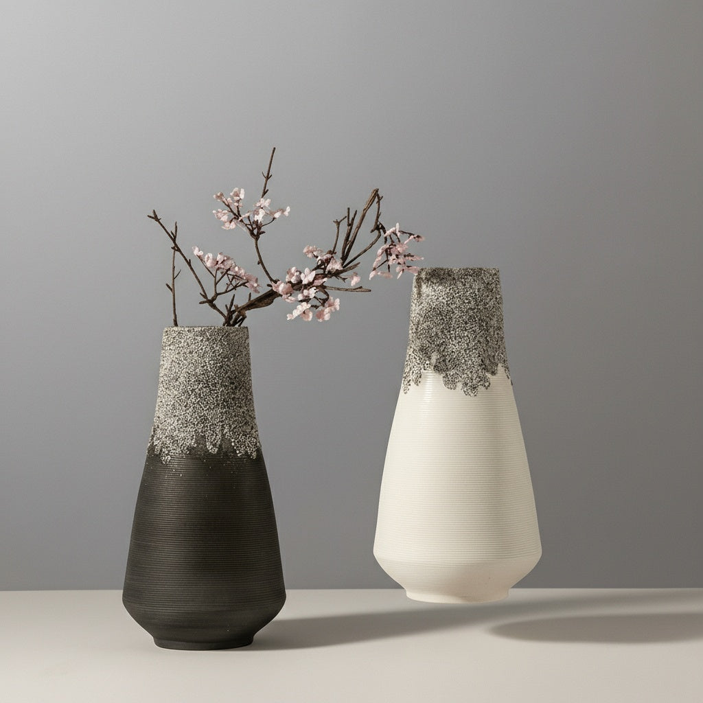 Two vases showing black and white variants with floral arrangement