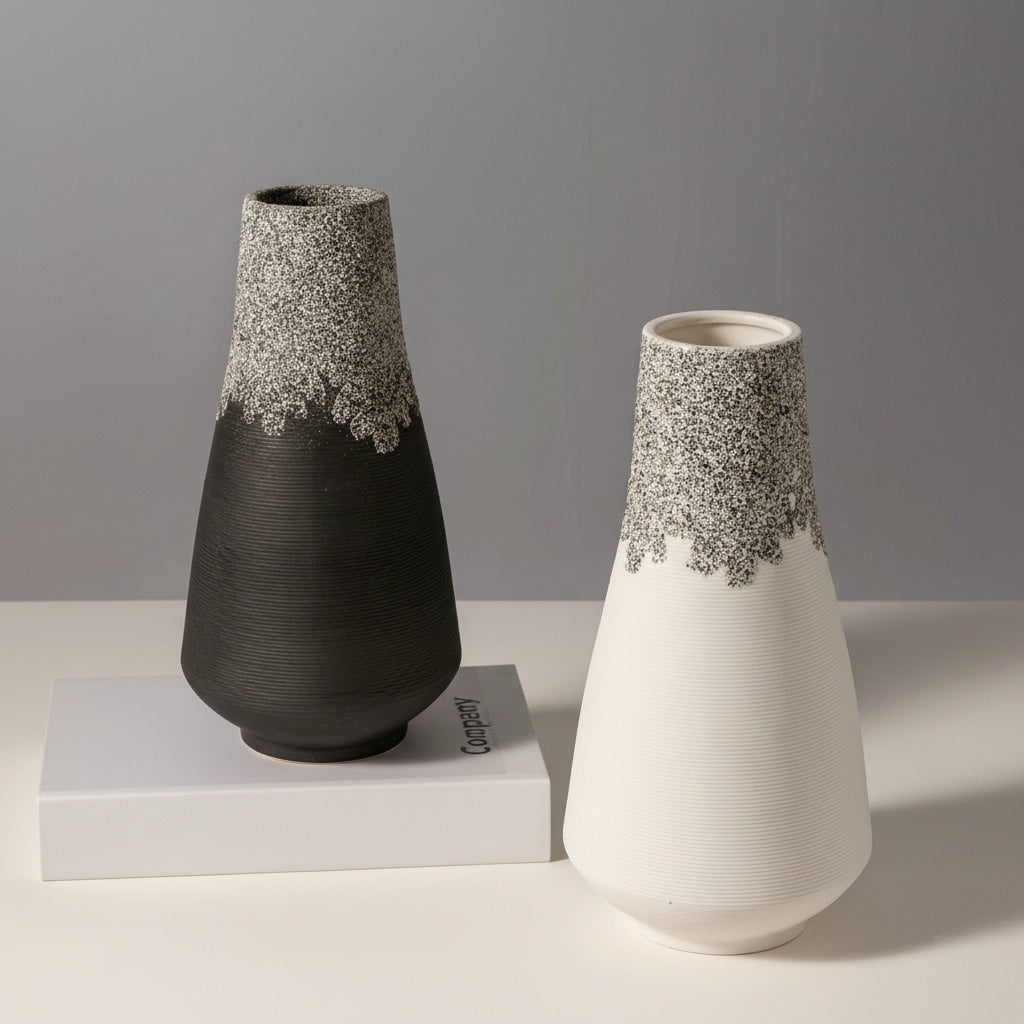 Black and white ceramic vases on white surface