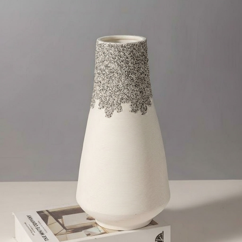 White ceramic vase with ribbed texture and speckled neck detail