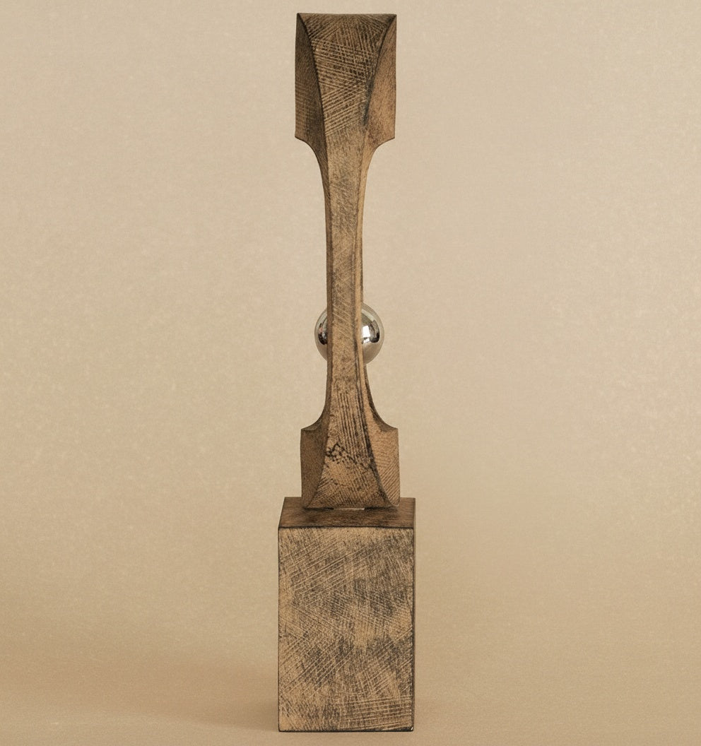 Side profile detail of textured wood sculpture base and frame