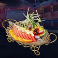 Tinted glass leaf shaped fruit bowl on gold metal stand filled with fresh fruit