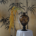 Tortoise shell glass vase with amber patterns on black pedestal base