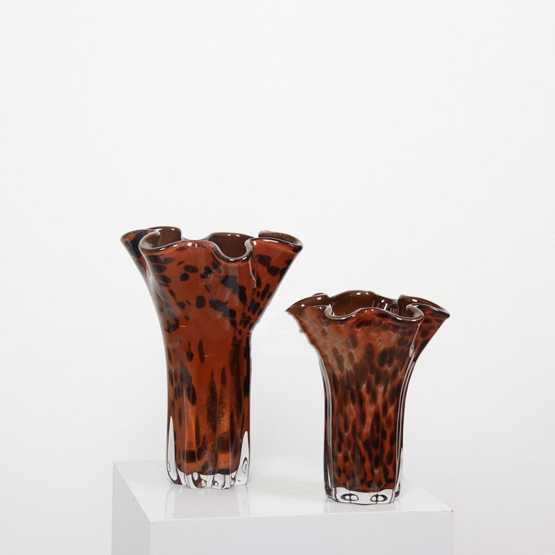 Two tortoise shell glass vases with wavy rims standing side by side