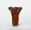 Close up of ruffled rim on tortoise shell glass vase