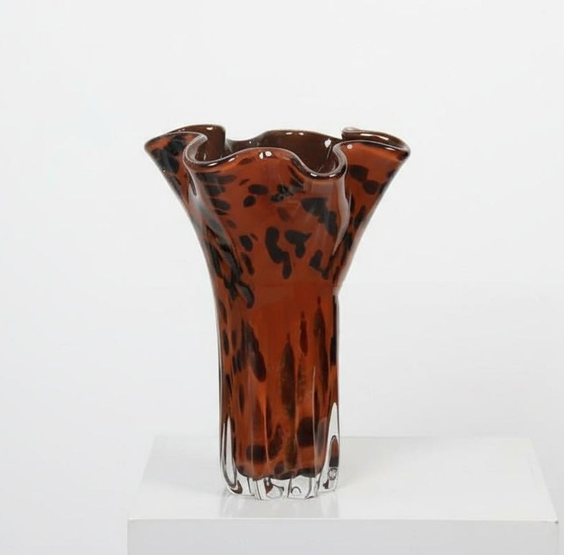 Close up of ruffled rim on tortoise shell glass vase