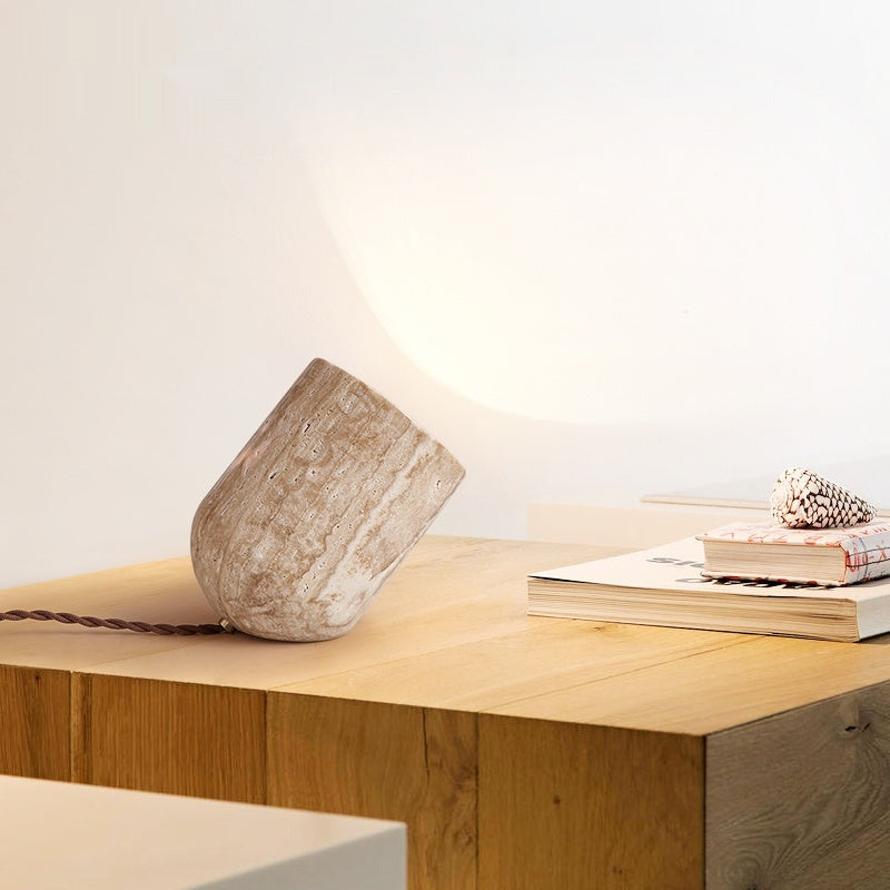 Travertine lamp on wooden desk showing porous texture