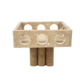 Front view of beige travertine footed bowl with circular cutouts