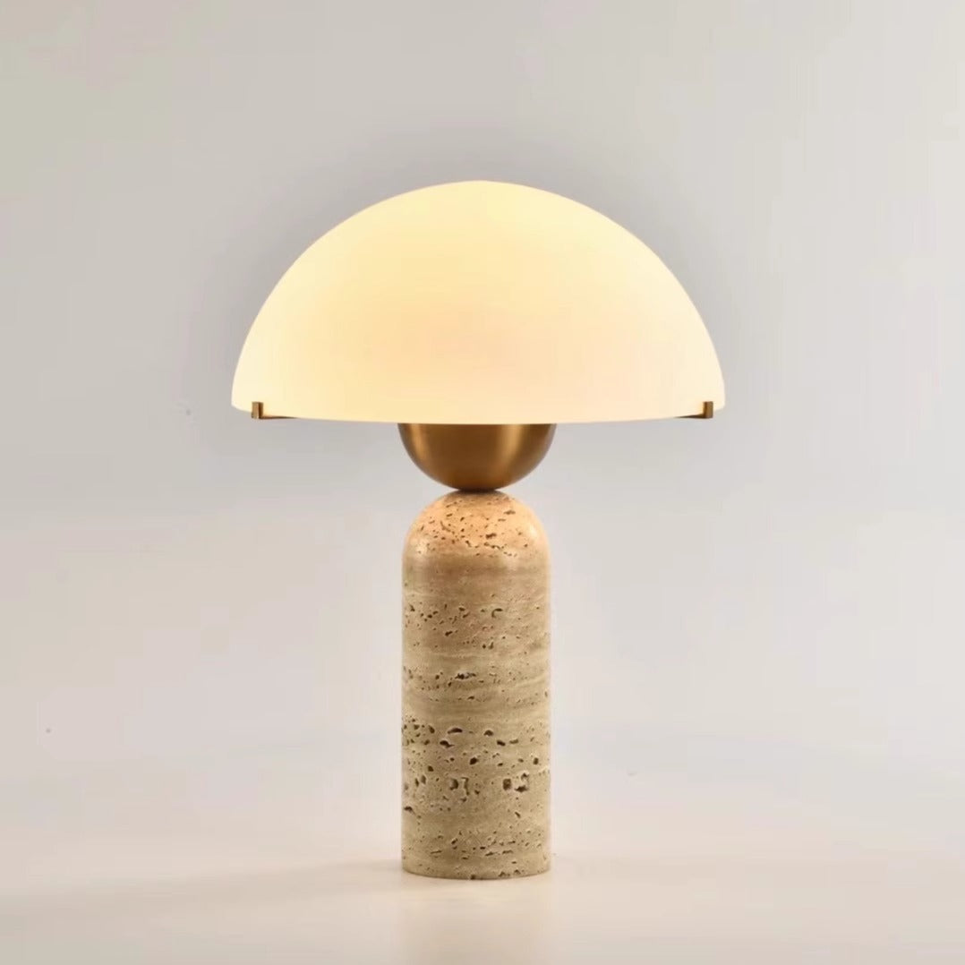 Front view of travertine and brass table lamp with glass dome