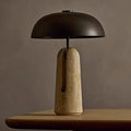 Front view of unlit travertine stone lamp with black dome
