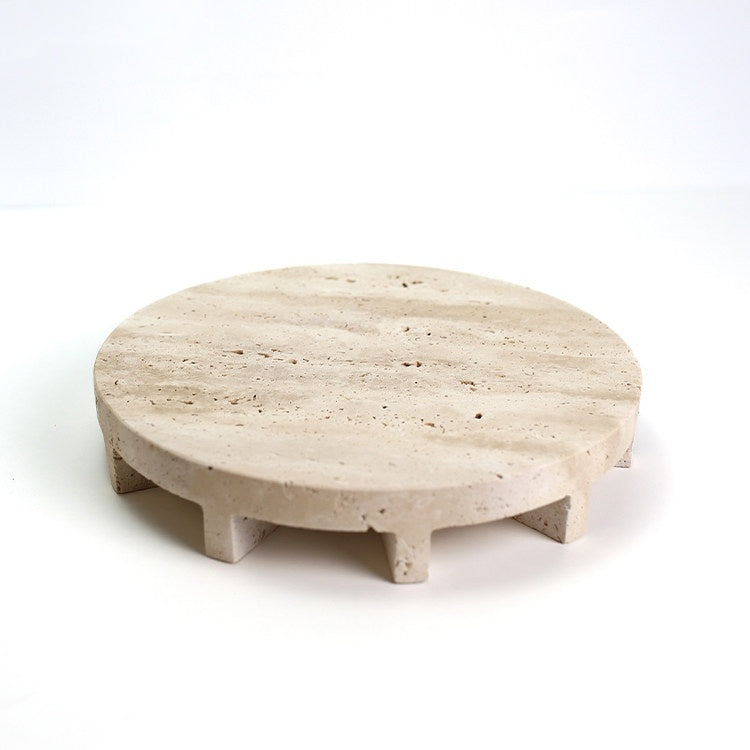 Minimalist round travertine stone riser stand studio view