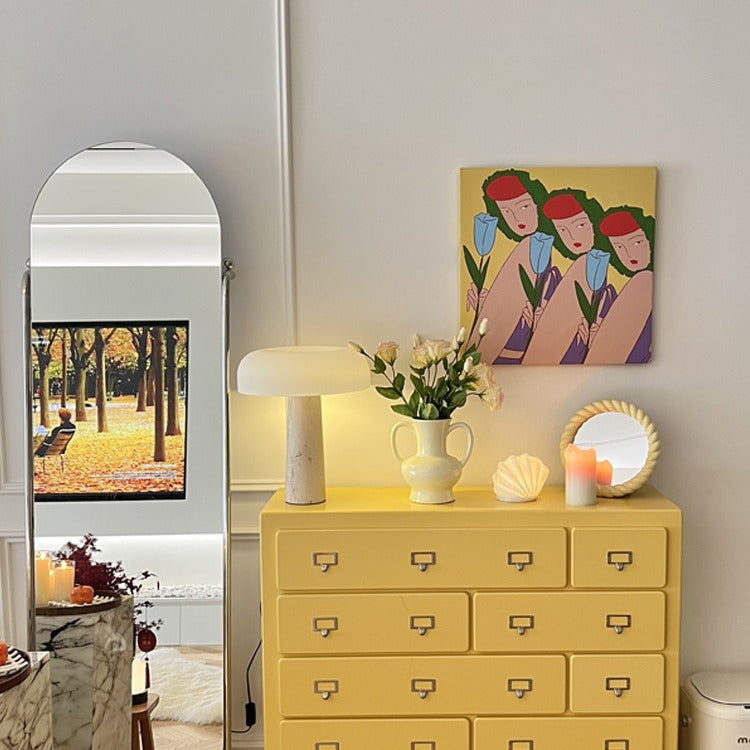 Lifestyle view of travertine lamp in bedroom setting with mirror