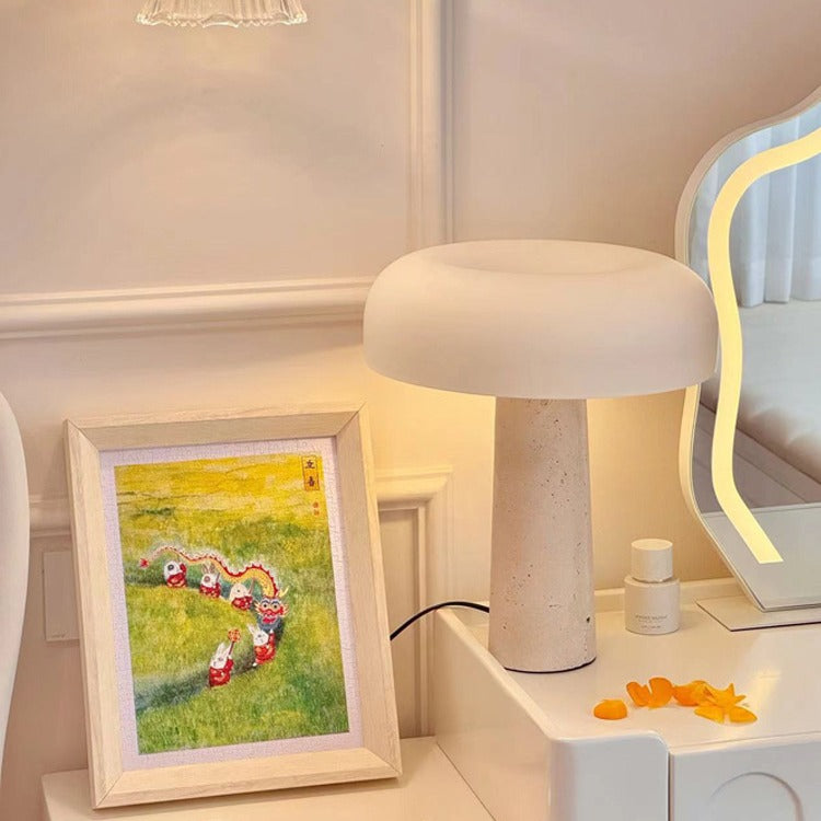 Close up of travertine lamp on white surface with framed art