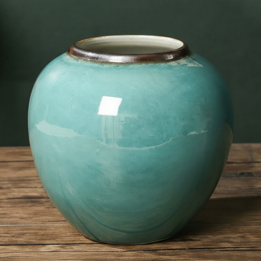 Turquoise glazed ceramic round vase front view