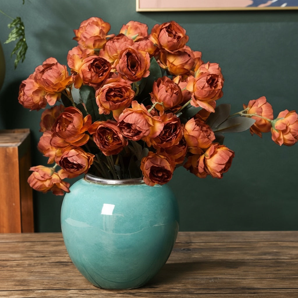Turquoise glazed ceramic round vase with floral arrangement