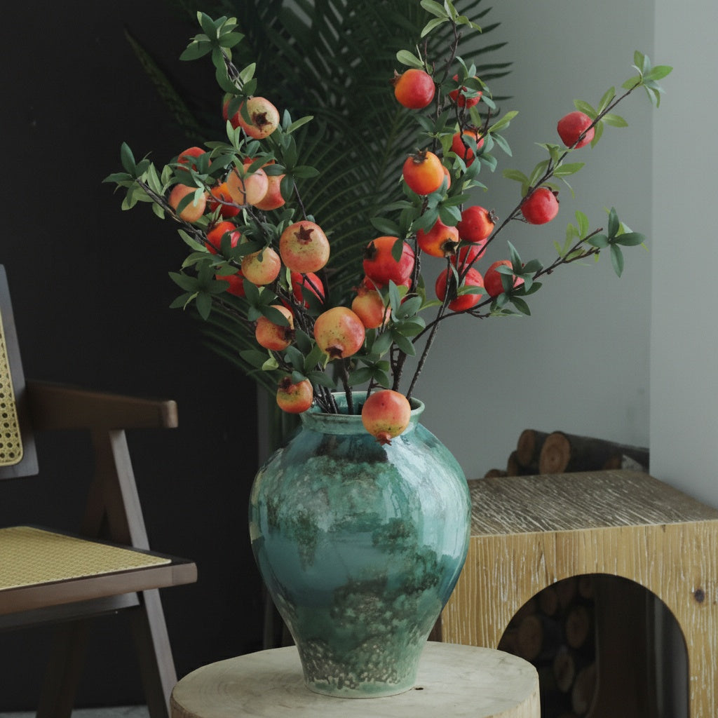 Turquoise reactive glaze ceramic urn vase with faux fruit branches