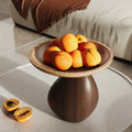 Two-Tone Wood Sculptural Pedestal Bowl holding fruit