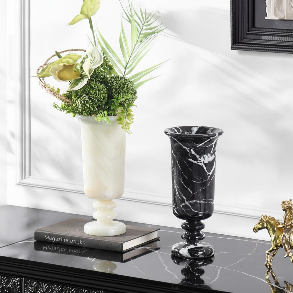 Group shot of black and white marble chalice vases with floral arrangement
