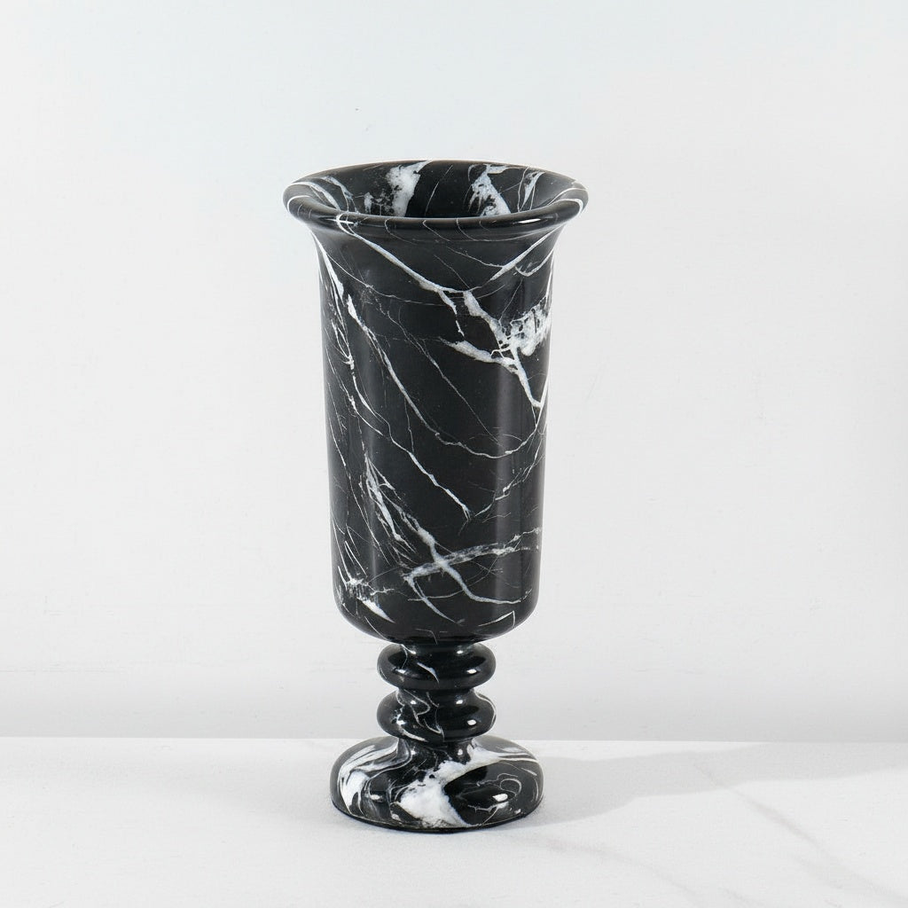 Detail of black marble pedestal vase with white veining