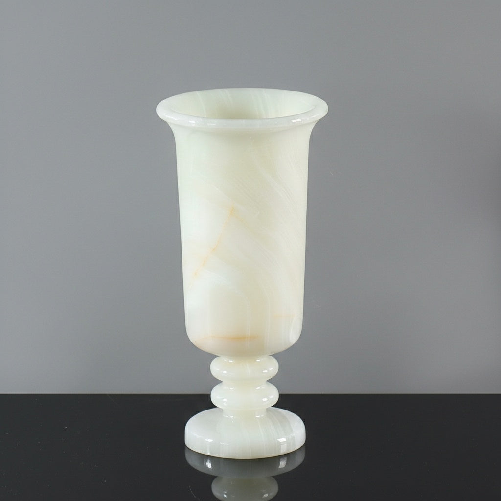 Detail of white marble pedestal vase with creamy translucent finish