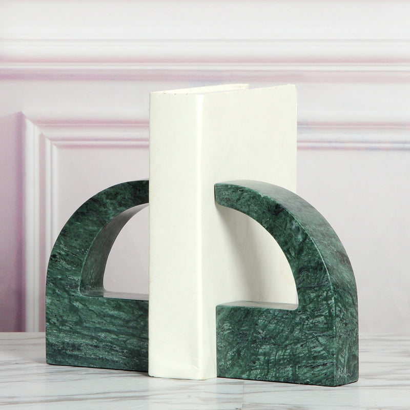 Green marble split arch bookends holding a white book showing rich dark green tones
