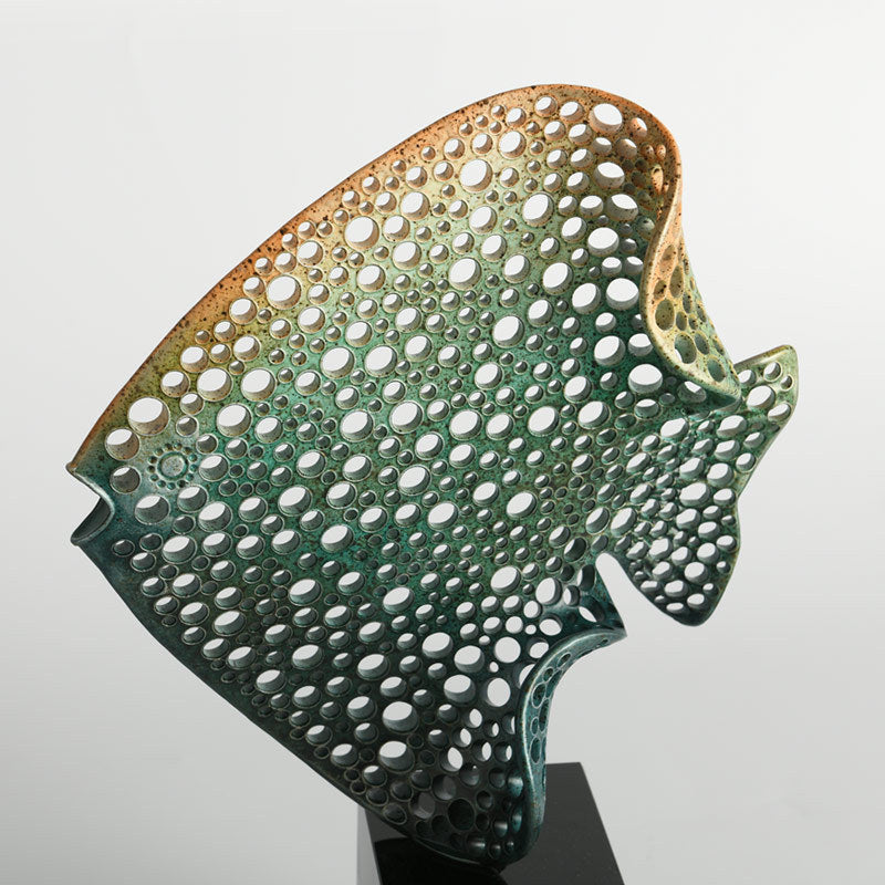 Close up of verdigris and bronze gradient finish on alloy sculpture