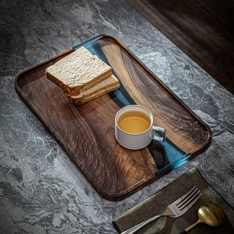 Walnut and blue resin serving tray styled with toast and tea cup for a breakfast setting