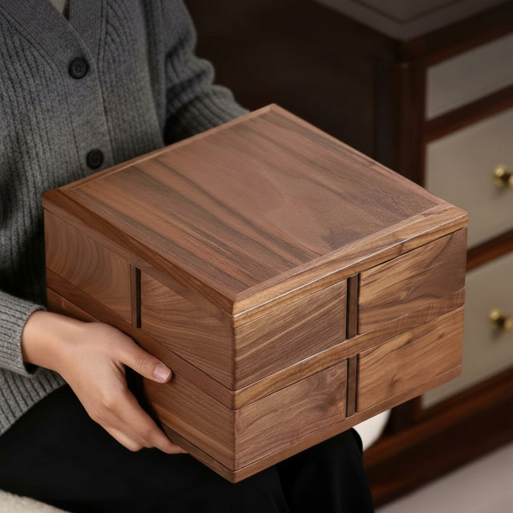 Closed square walnut wood box held in hands