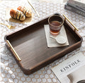 Top down view of wooden tray styling coffee glass, sugar, and pastries on a lace tablecloth