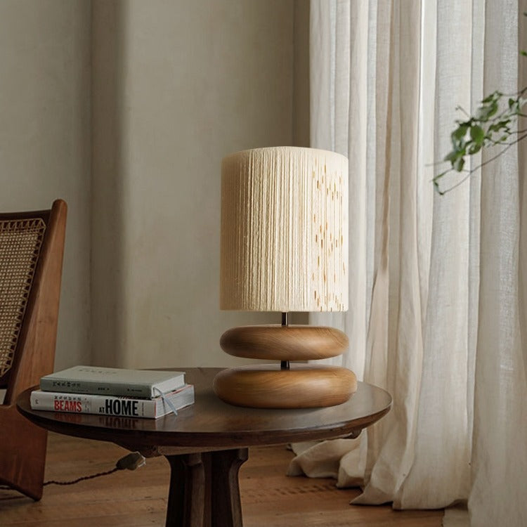 Lifestyle shot of walnut wood lamp on side table with books