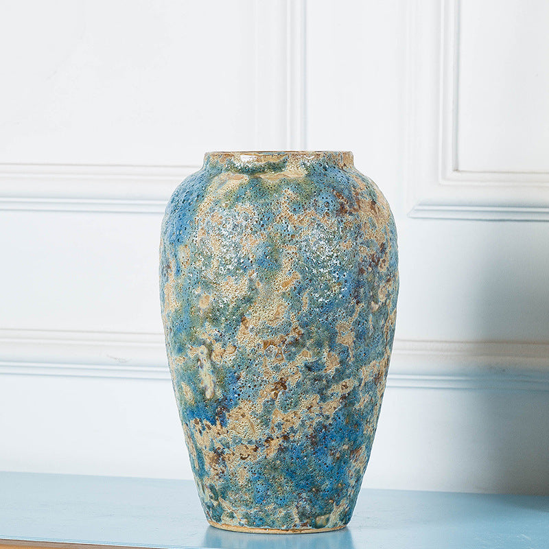 Empty tall weathered blue ceramic vase showing texture