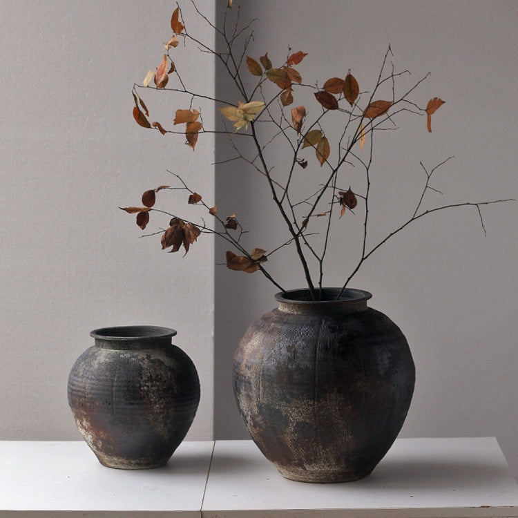 Large ceramic vase styled with autumn branches