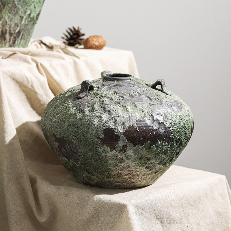 Detailed close up of weathered moss green ceramic jar texture