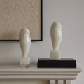 White alabaster abstract owl sculpture styled on mantelpiece