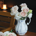 White And Blue Porcelain Fluted Pitcher Used As A Floral Vase