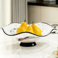 White and black marbled glass fruit bowl with pears on marble table