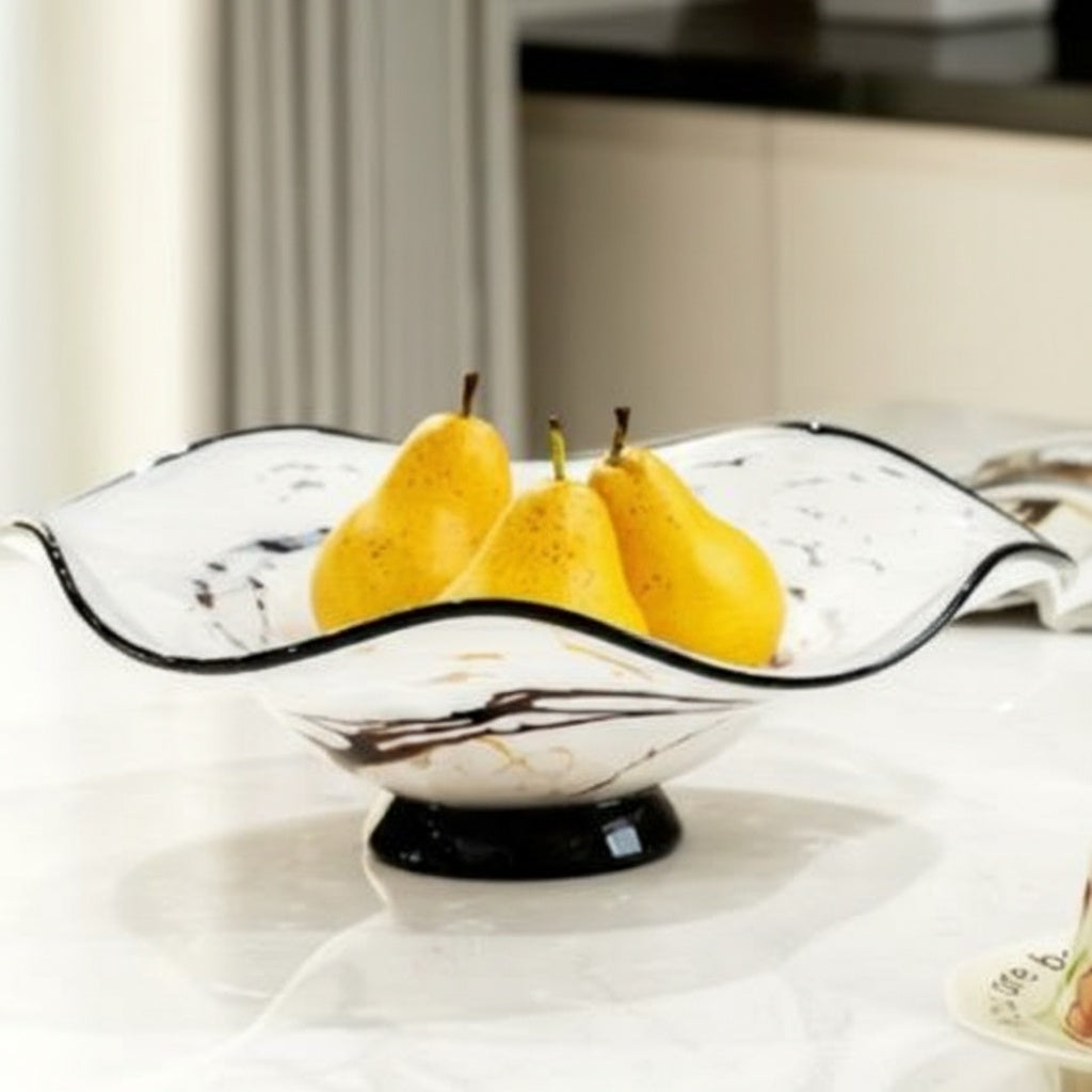 White and black marbled glass fruit bowl with pears on marble table