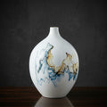 Round white ceramic vase with abstract blue and brown glaze for modern decor