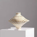 Front view of white and brown dotted ceramic diamond vase on pedestal