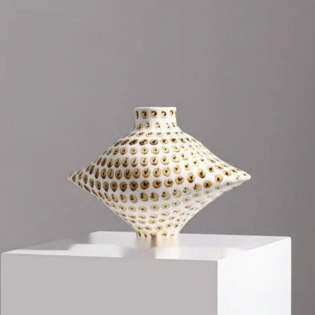 Front view of white and brown dotted ceramic diamond vase on pedestal