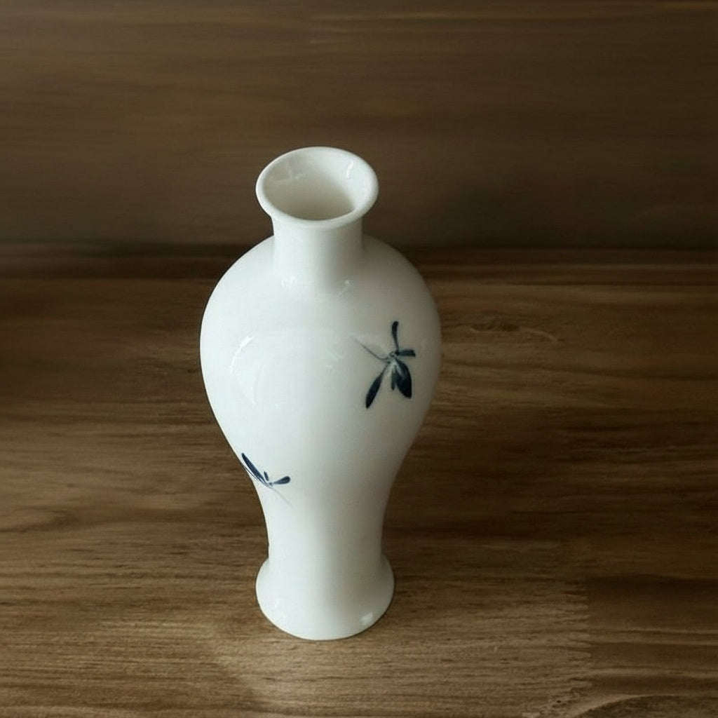 Front view of white ceramic botanical vase
