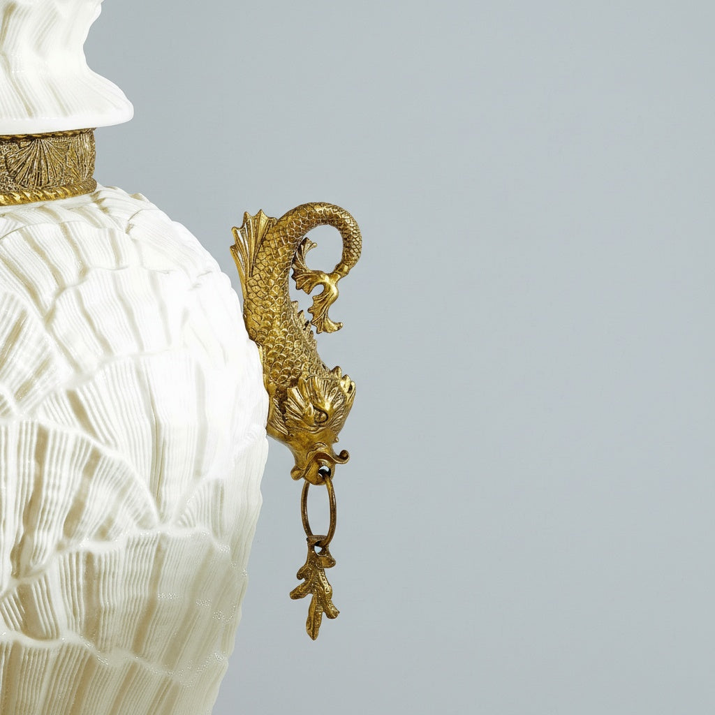 Close up detail of brass sea creature handle on white jar