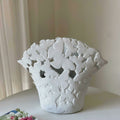 Angled view of the white ceramic butterfly vase