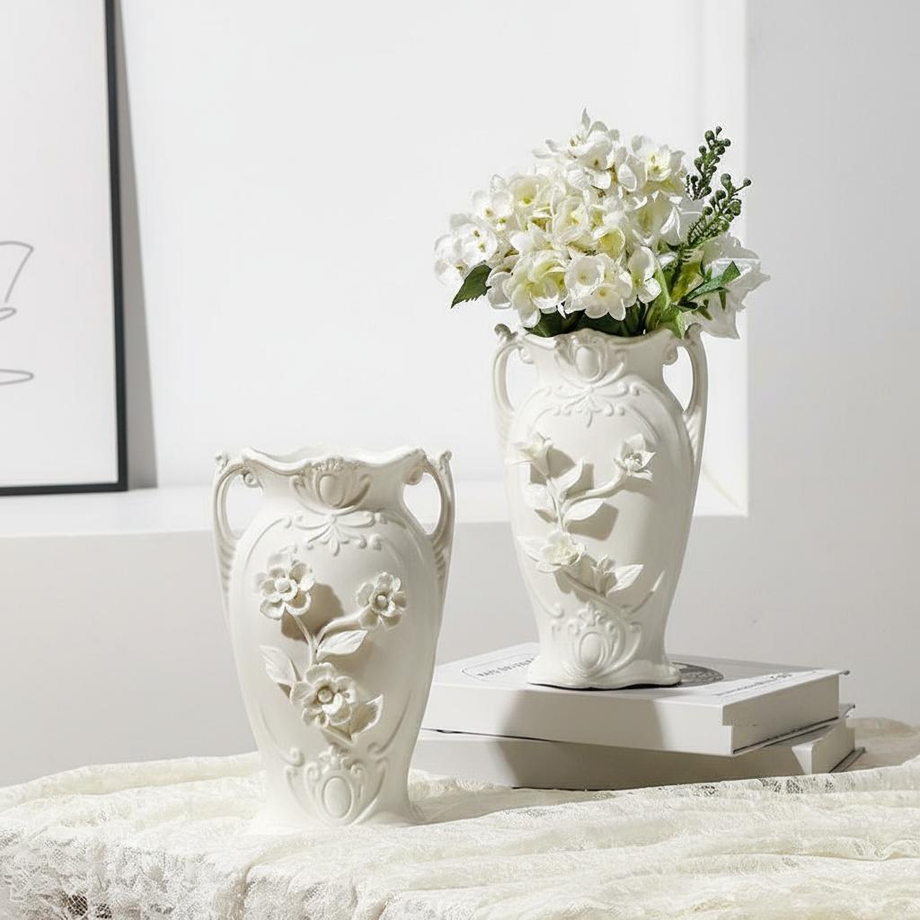 White ceramic vase with 3D floral relief details on lace tablecloth