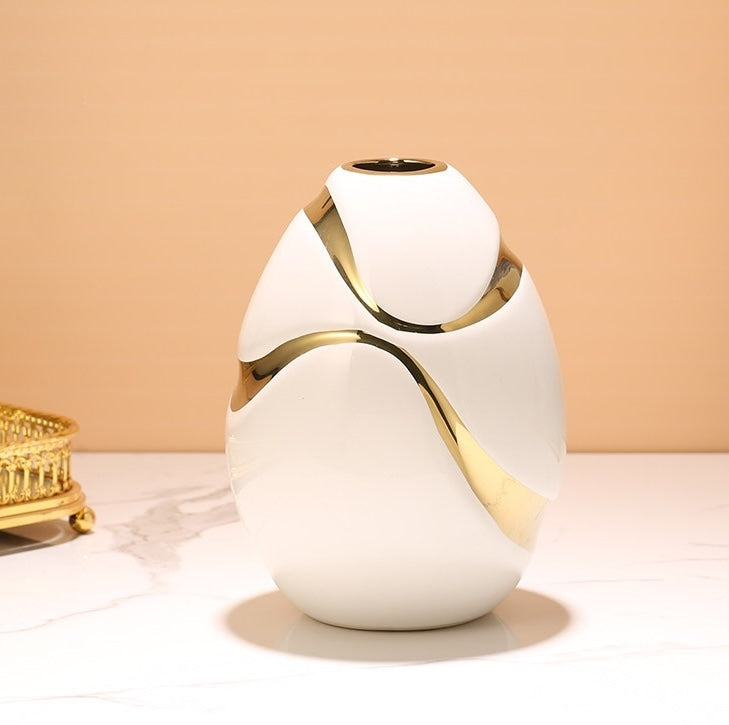 White ceramic egg shaped vase with gold ribbon detail